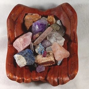 A Ruby And Gem Stones In Wooden Cupped Hands